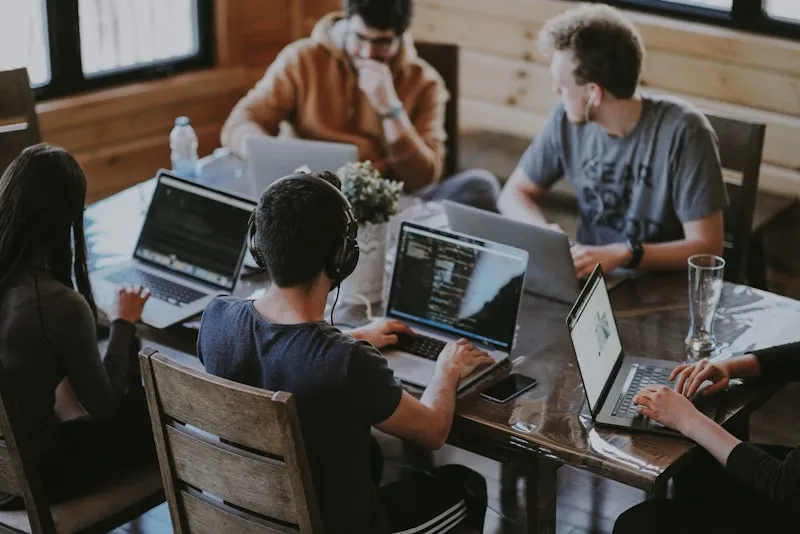 Equipo de negocio colaborando con portátiles